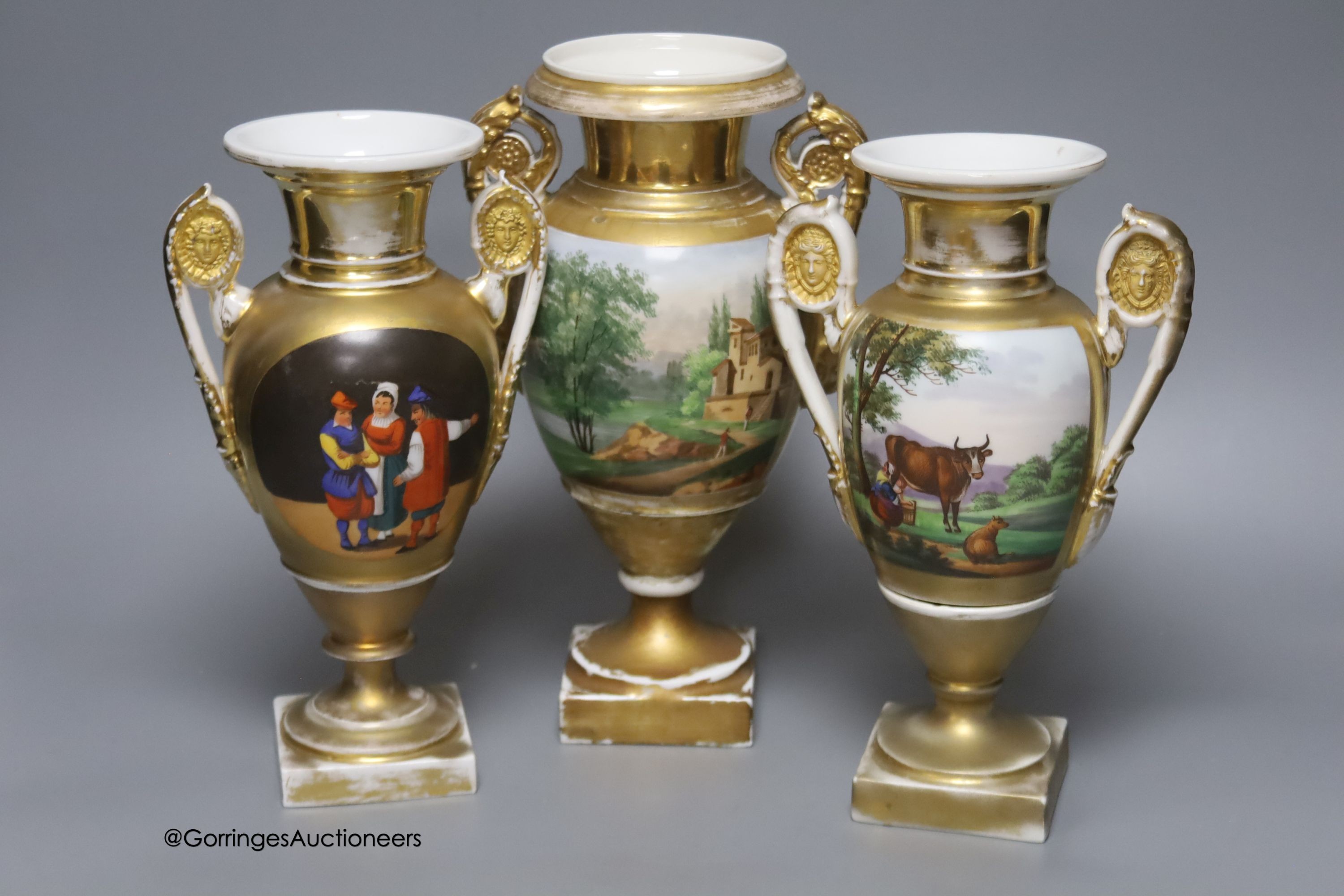 A 19th century French porcelain garniture of three vases, height 27cm